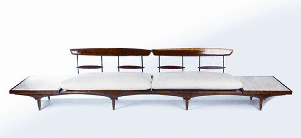 Sofa by Phillip Lloyd Powell (1919-2008), c. 1960s. Walnut and travertine; height 30 ½, length 12 feet, 5 inches, depth 27 inches. Courtesy of Todd Merrill Antiques, New York.